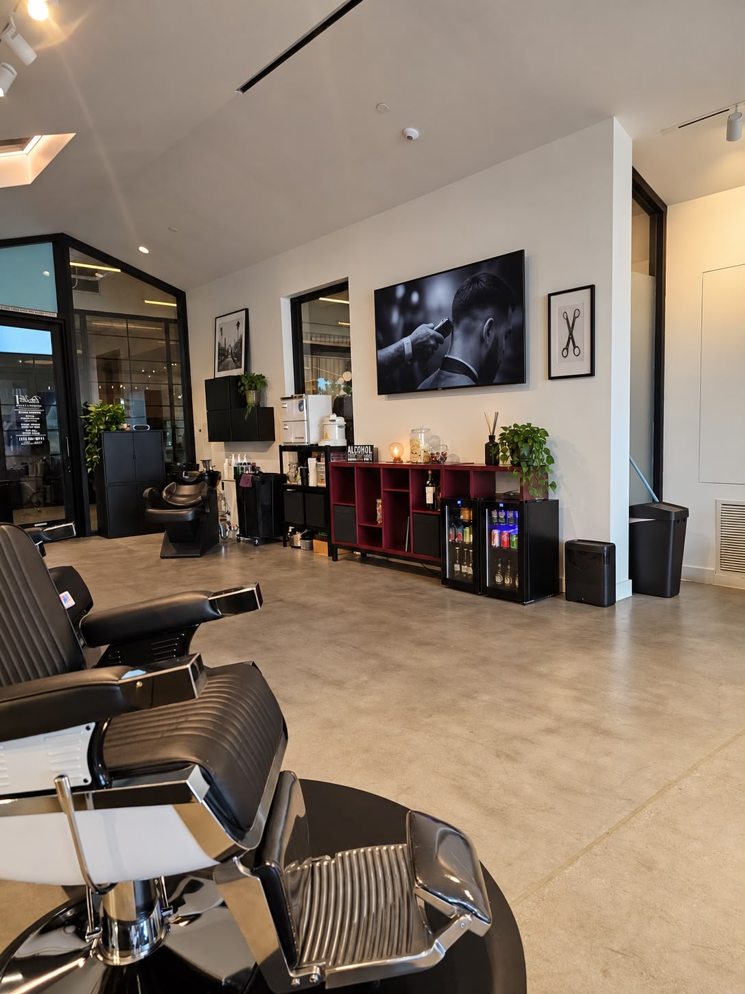 Refreshment fridge and barber chairs inside the shop